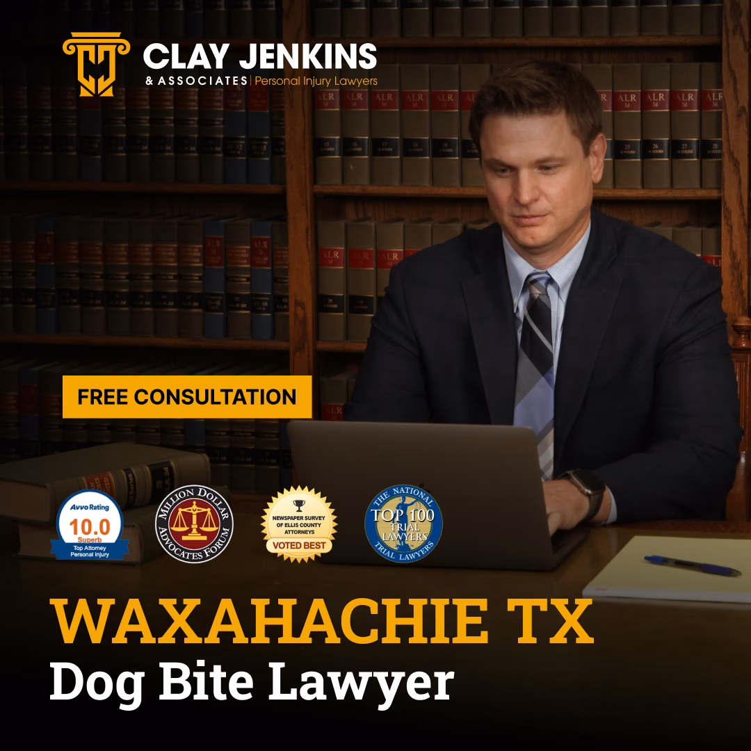 Personal injury lawyer at desk with law books, Clay Jenkins & Associates logo, and professional credentials displayed