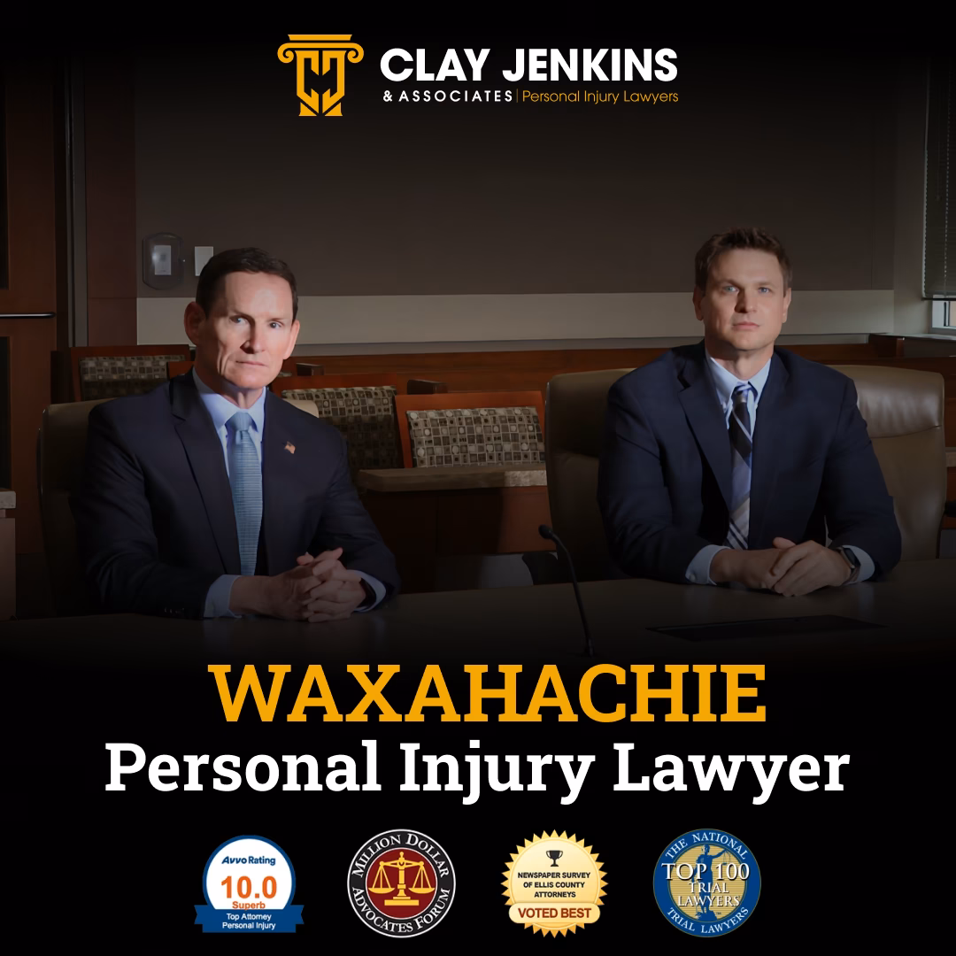 Two professional male attorneys in business suits seated at conference table with Clay Jenkins & Associates logo and Waxahachie Personal Injury Lawyer