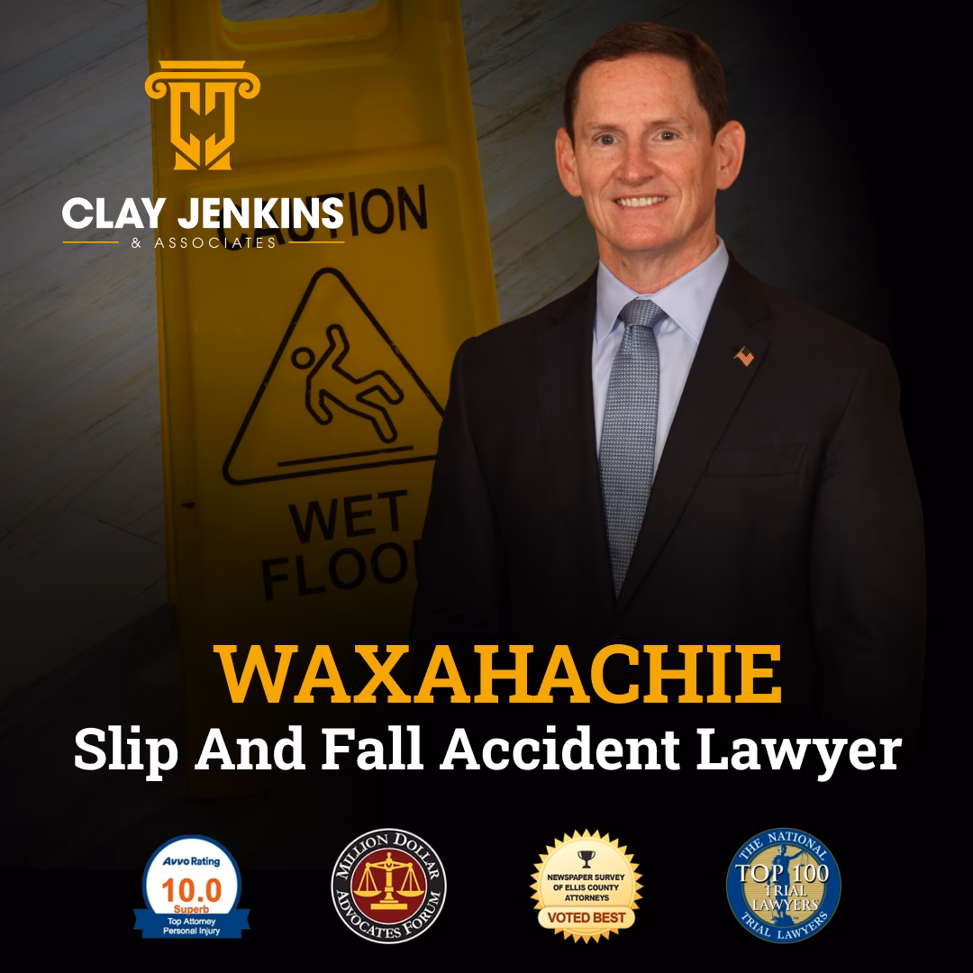 Premises liability attorney in business suit standing next to wet floor caution sign with Clay Jenkins & Associates branding